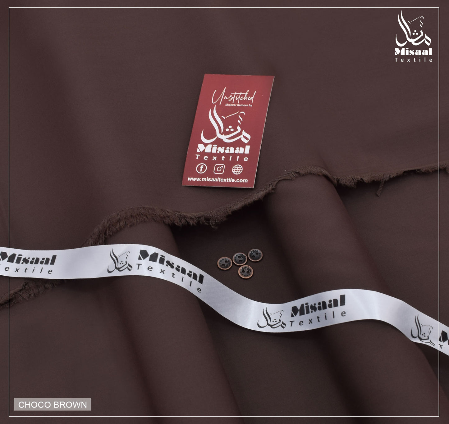 Brown fabric with Misaal Textile branding and a tag on a dark background