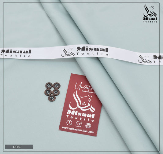 Misaal Textile branded ribbon, buttons, and tag on a light gray fabric background