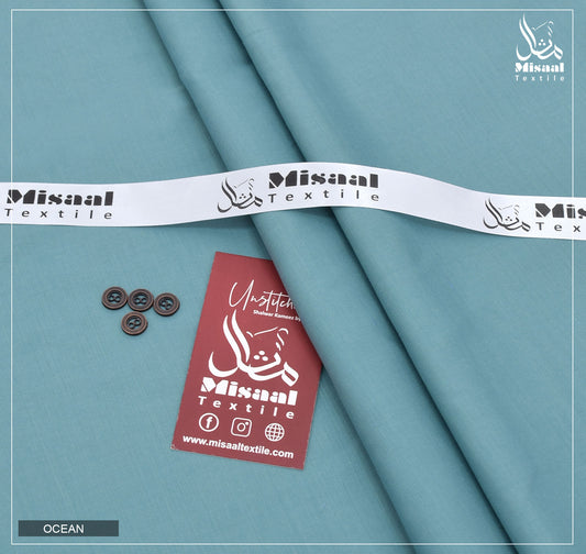 Misaal Textile fabric with buttons and a tag on a teal background
