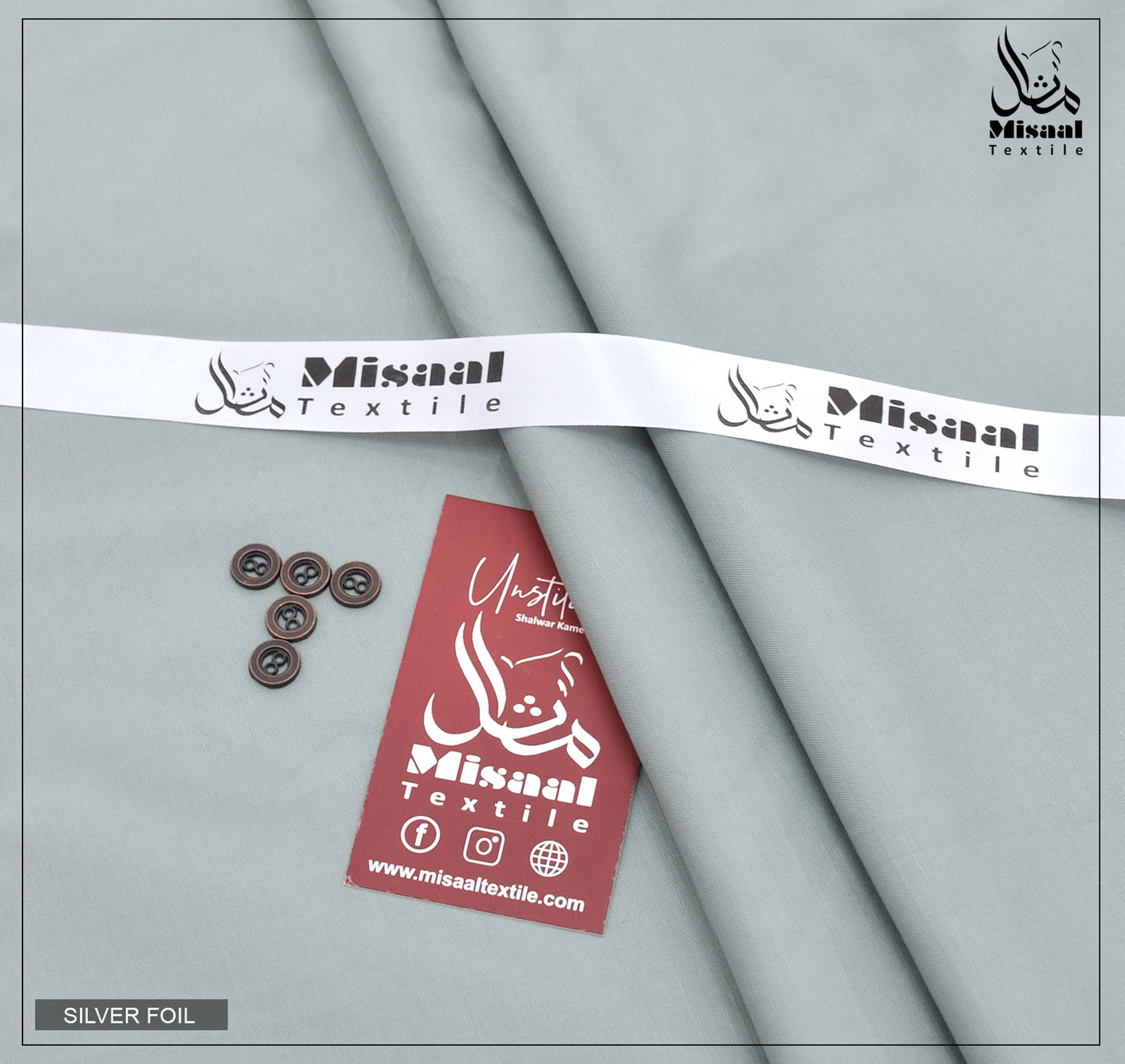 Gray fabric with silver foil, buttons, and a red tag with 'Misaal Textile' branding on a gray background.