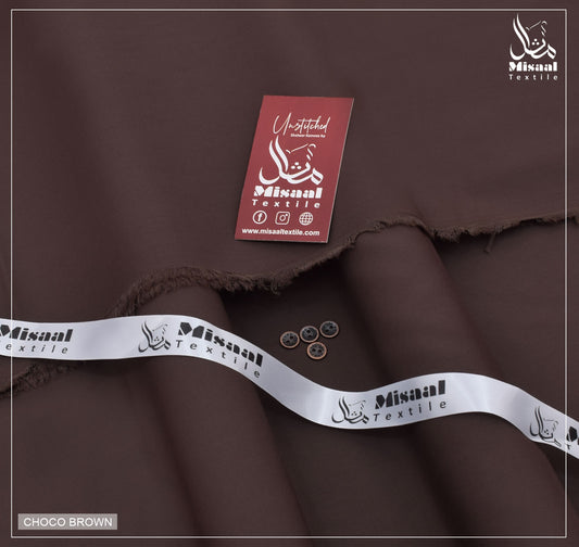 Brown fabric with Misaal Textile branding and a tag on a dark background